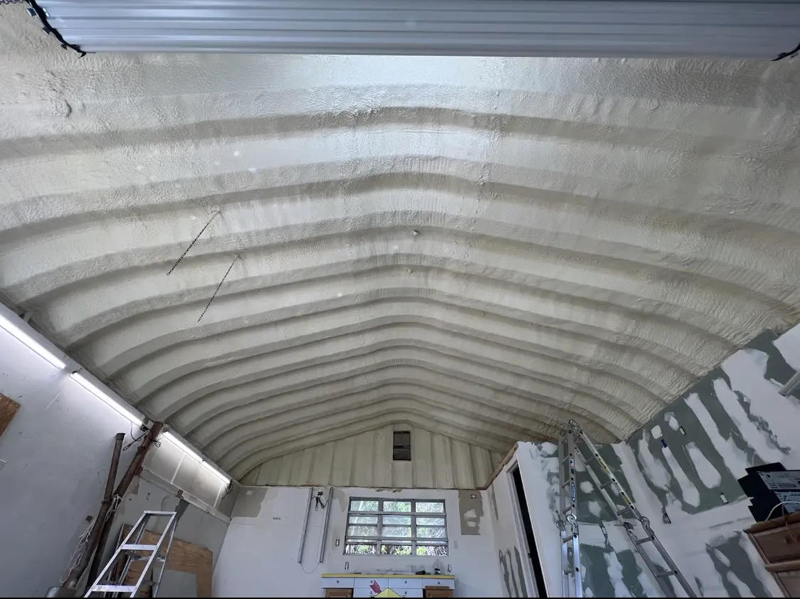 Spray polyurethane foam applied to the underside of a metal roof deck in Melrose
